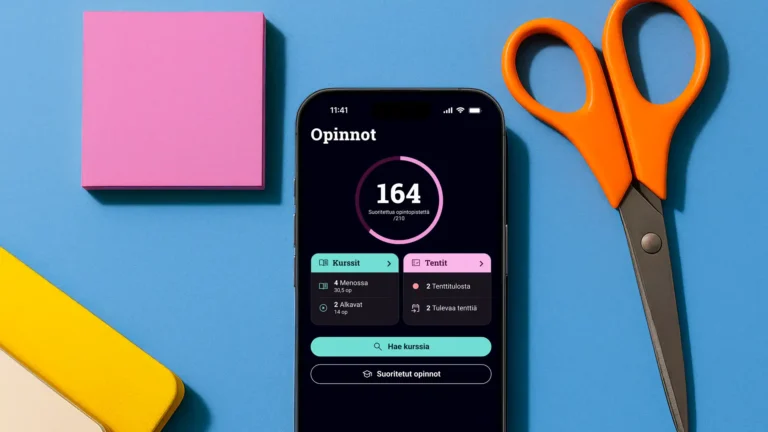 Uusi Tuudo-sovellus sinisellä pöydällä. Sen vieressä on sakset ja vaaleanpunaisia post-it -lappuja.